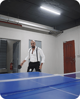 A teammate playing table tennis