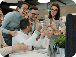 The team celebrating together around a desk